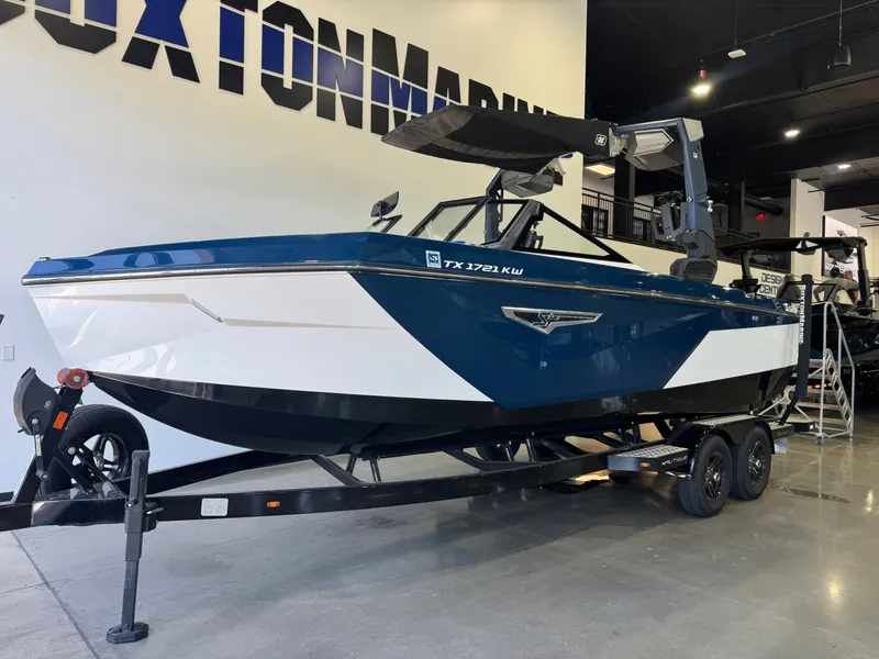 Slide: The Image of 2023 Nautique Super Air Nautique S23 boat in showroom. - 2