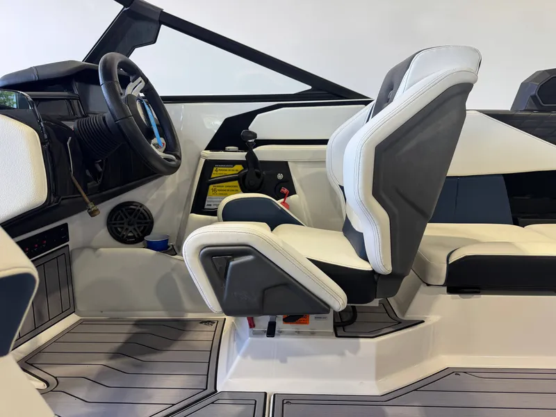 Slide: The Image of Interior of 2023 Nautique Super Air Nautique S23 with steering wheel and seats. - 23