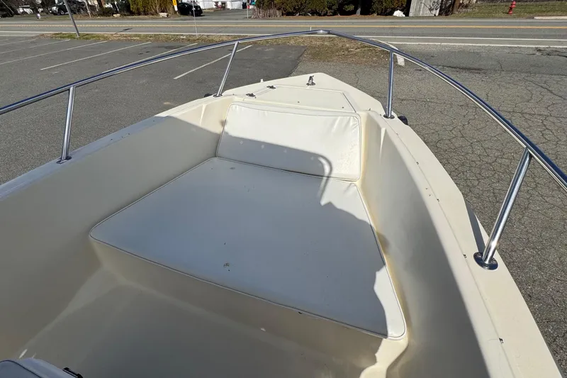 Slide: The Image of 1996 Scout 202 Dorado boat interior with white seating and metal railings. - 12