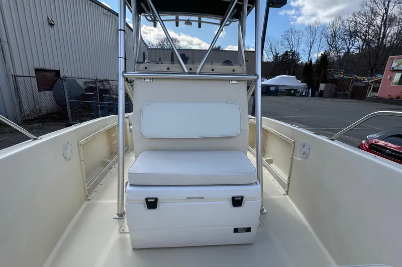 Slide: The Image of 1996 Scout 202 Dorado boat interior with cushioned seating and storage. - 13