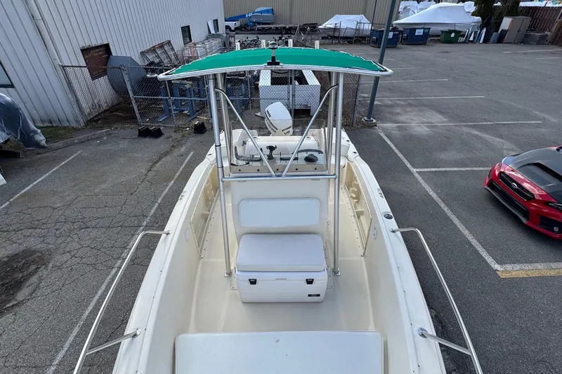 Slide: The Image of 1996 Scout 202 Dorado boat with green canopy in a parking lot. - 14