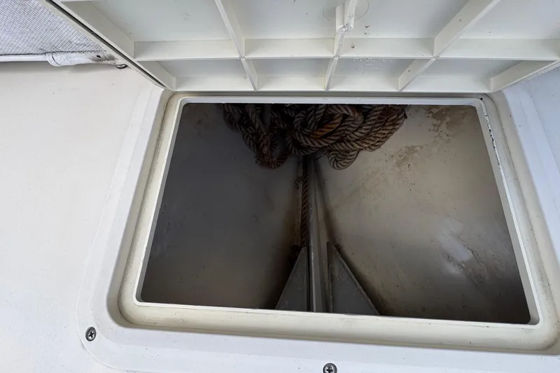 Slide: The Image of Open storage compartment on 1996 Scout 202 Dorado boat with coiled rope inside. - 16
