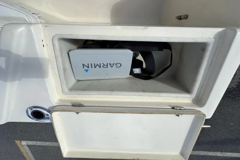Slide: The Image of Open storage compartment on 1996 Scout 202 Dorado boat with Garmin device inside. - 18