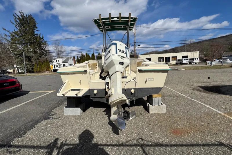 Slide: The Image of 1996 Scout 202 Dorado boat with Evinrude 150 engine on concrete blocks in parking lot. - 5