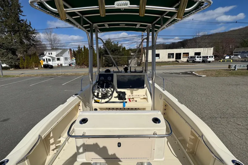 Slide: The Image of 1996 Scout 202 Dorado boat interior with steering wheel and console, parked outdoors. - 6
