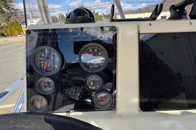 Slide: The Image of Dashboard of a 1996 Scout 202 Dorado boat with gauges and controls. - 7