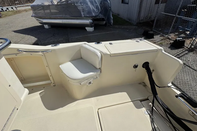 Slide: The Image of 1996 Scout 202 Dorado boat interior with seating and storage compartments. - 9
