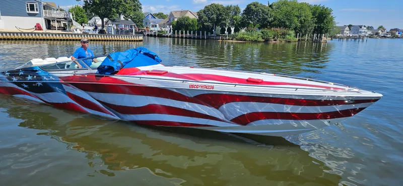 Slide: The Image of 2004 Formula 382 FASTech boat with American flag design on calm water. - 2