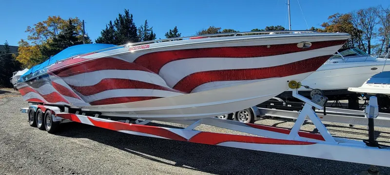 Slide: The Image of 2004 Formula 382 FASTech boat with red and white design on trailer. - 3
