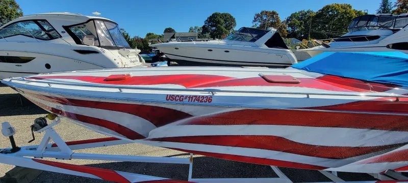 Slide: The Image of 2004 Formula 382 FASTech boat with red design on a trailer. - 7