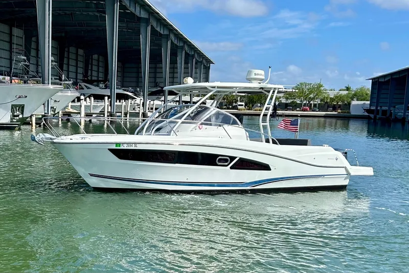 The Image of 2019 Jeanneau Leader 9.0 WA boat docked in marina, clear sky background. - 0