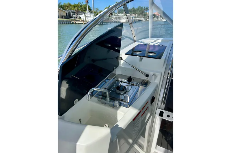Slide: The Image of 2019 Jeanneau Leader 9.0 WA boat interior with compact kitchen setup. - 10
