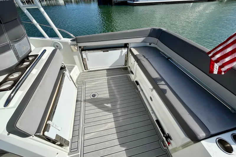 Slide: The Image of 2019 Jeanneau Leader 9.0 WA boat deck with seating and American flag. - 11