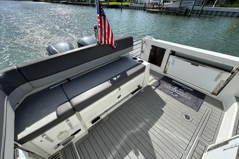 Slide: The Image of 2019 Jeanneau Leader 9.0 WA boat deck with seating and American flag. - 16