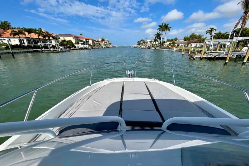Slide: The Image of 2019 Jeanneau Leader 9.0 WA cruising through a scenic waterfront neighborhood. - 18