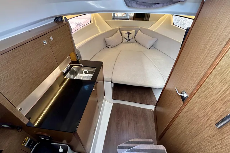 Slide: The Image of 2019 Jeanneau Leader 9.0 WA cabin interior with kitchenette and cozy seating area. - 21
