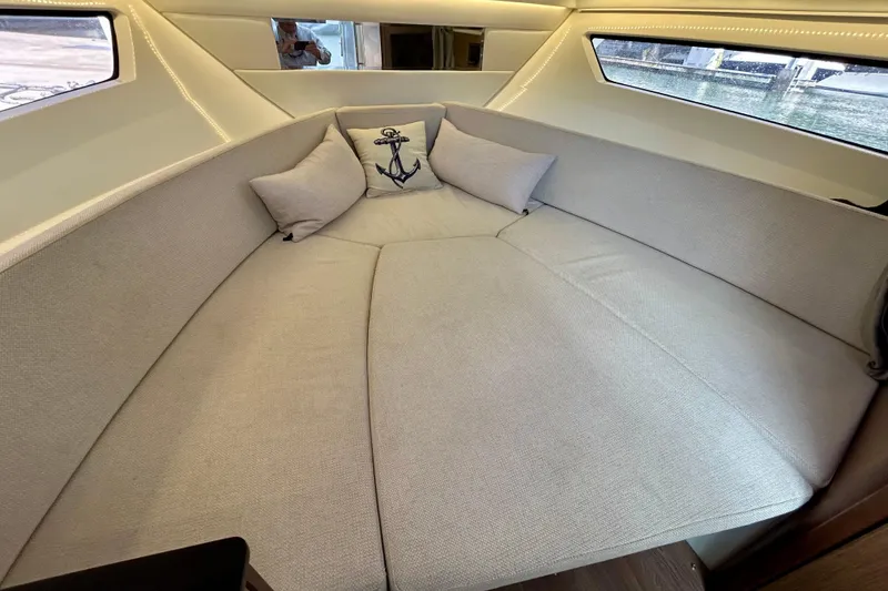 Slide: The Image of Interior cabin of 2019 Jeanneau Leader 9.0 WA with cozy bedding and anchor-themed pillow. - 23