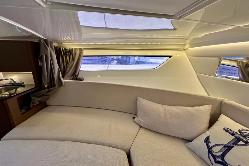 Slide: The Image of Interior of 2019 Jeanneau Leader 9.0 WA boat, featuring cozy seating and nautical decor. - 25