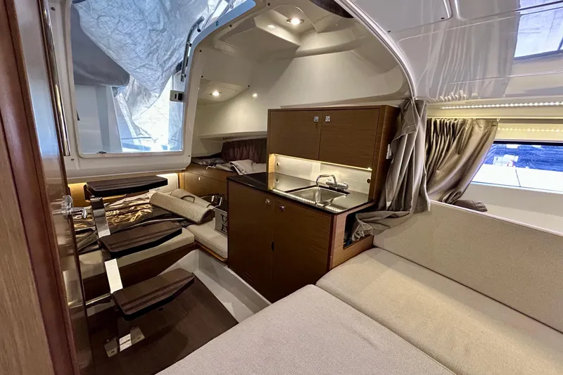 Slide: The Image of 2019 Jeanneau Leader 9.0 WA cabin interior with kitchenette and seating area. - 26