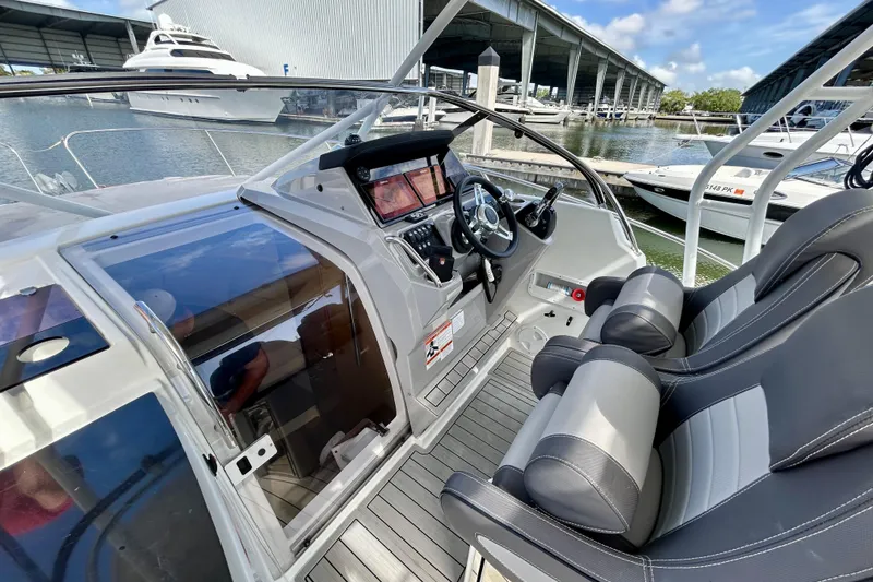 Slide: The Image of 2019 Jeanneau Leader 9.0 WA boat cockpit with modern controls and seating at marina. - 7