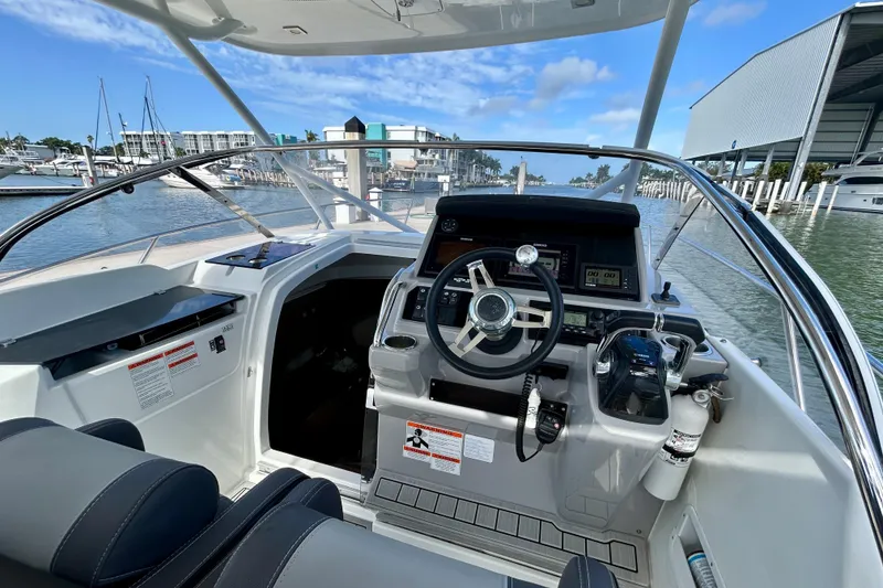 Slide: The Image of Cockpit view of 2019 Jeanneau Leader 9.0 WA boat, featuring modern controls and steering wheel. - 8