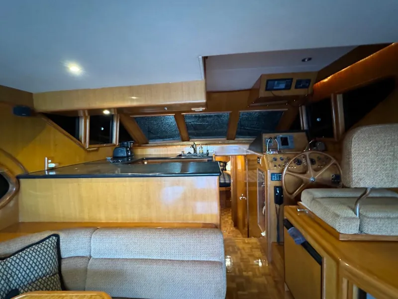 Slide: The Image of Interior of 2004 Ocean Alexander 42 yacht with helm, seating, and wooden finishes. - 11