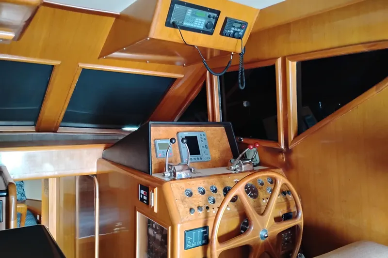 Slide: The Image of Helm of 2004 Ocean Alexander 42 Altus yacht with wooden steering wheel and navigation instruments. - 12