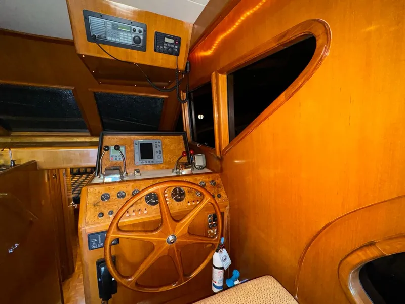 Slide: The Image of 2004 Ocean Alexander 42 yacht helm with wooden steering wheel and navigation equipment. - 13
