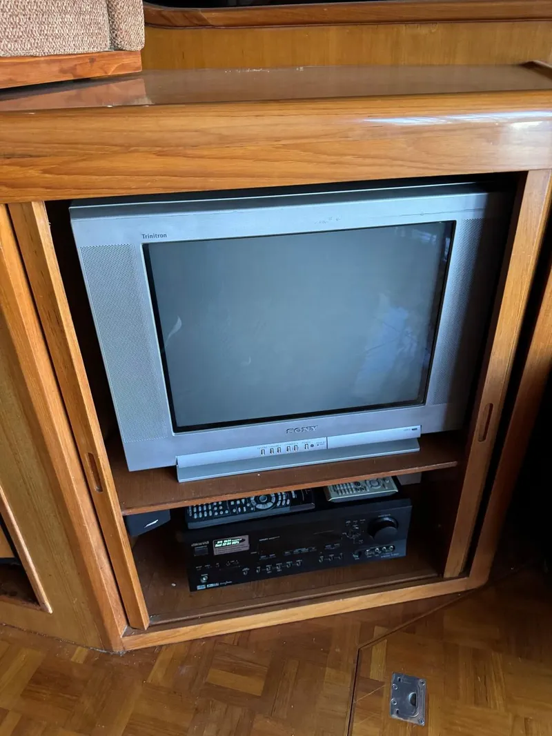 Slide: The Image of 2004 Ocean Alexander 42 interior with vintage TV and audio equipment in wooden cabinet. - 15