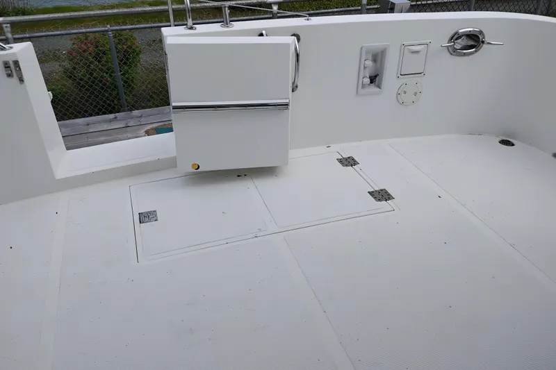 Slide: The Image of 2004 Ocean Alexander 42 Altus boat deck with storage compartments and railing. - 2