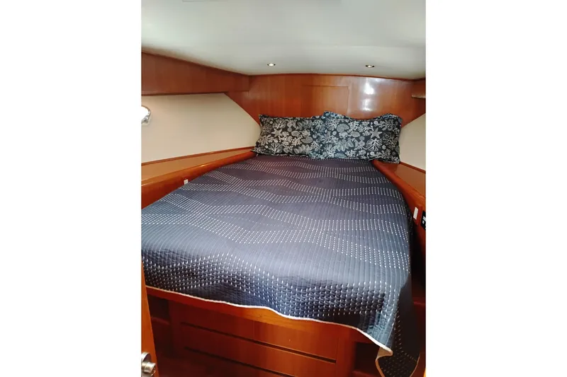 Slide: The Image of Cozy cabin interior of 2004 Ocean Alexander 42 Altus yacht with bed and floral pillows. - 21