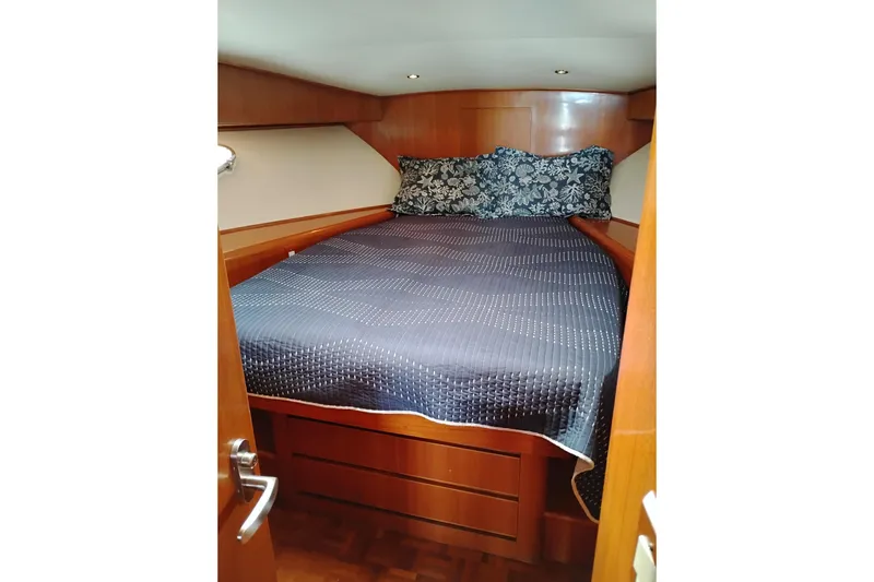 Slide: The Image of Cozy cabin bedroom in 2004 Ocean Alexander 42 Altus yacht with wooden interior. - 22