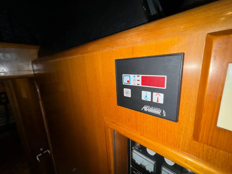 Slide: The Image of Control panel on 2004 Ocean Alexander 42 yacht, featuring wood finish and digital display. - 23