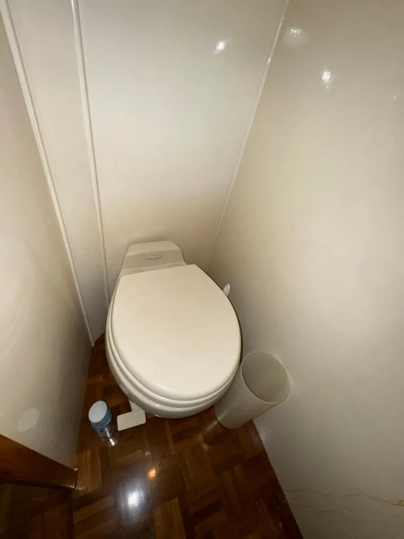 Slide: The Image of 2004 Ocean Alexander 42 yacht bathroom with toilet and wooden flooring. - 26