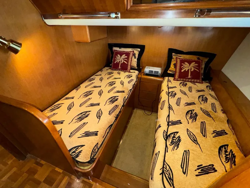 Slide: The Image of Twin cabin beds in 2004 Ocean Alexander 42 yacht with tropical-themed bedding. - 28