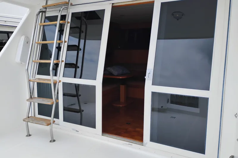 Slide: The Image of Stainless steel ladder and sliding glass door on 2004 Ocean Alexander 42 Altus yacht. - 3