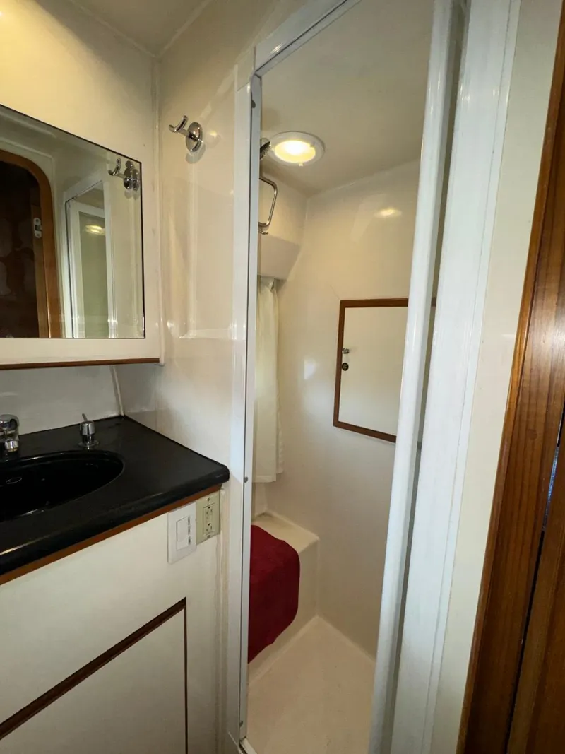 Slide: The Image of Bathroom interior of 2004 Ocean Alexander 42 yacht, featuring sink and shower. - 30