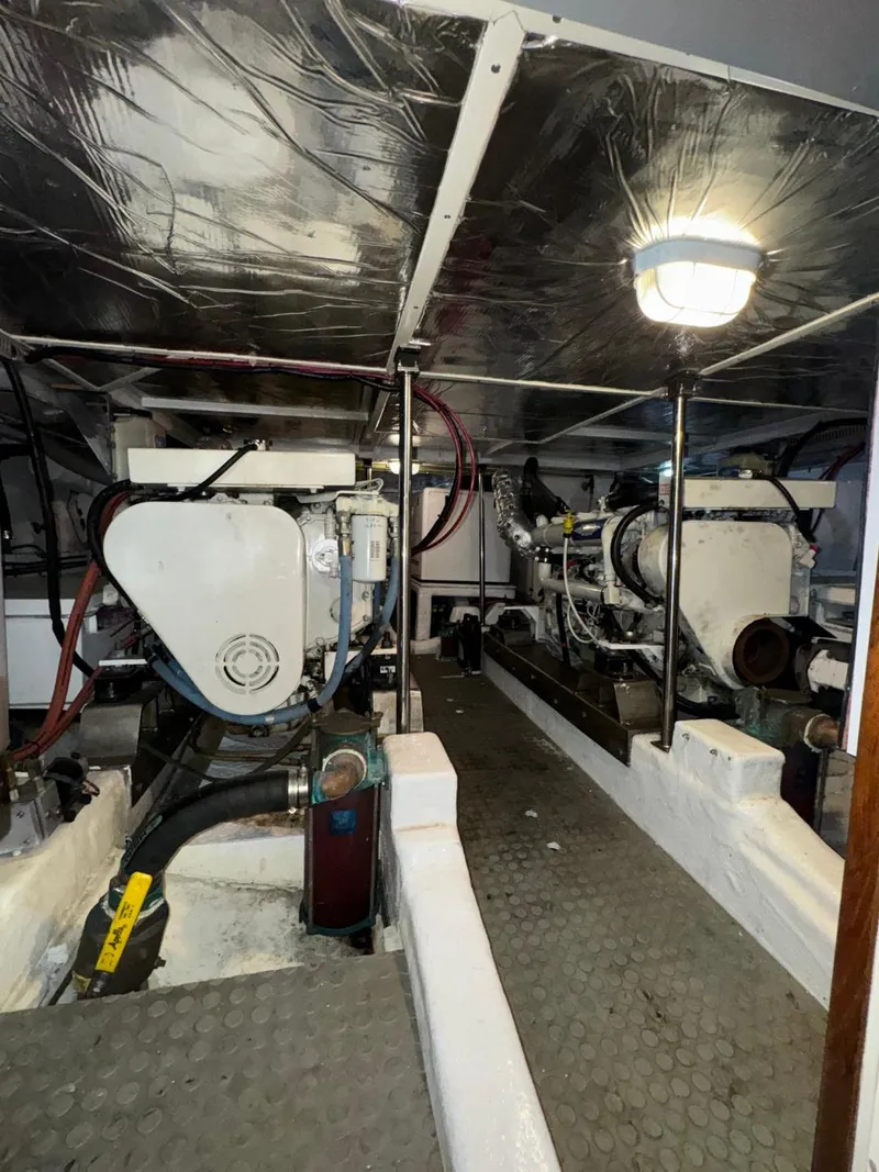 Slide: The Image of Engine room of 2004 Ocean Alexander 42 yacht, featuring dual engines and clean layout. - 31