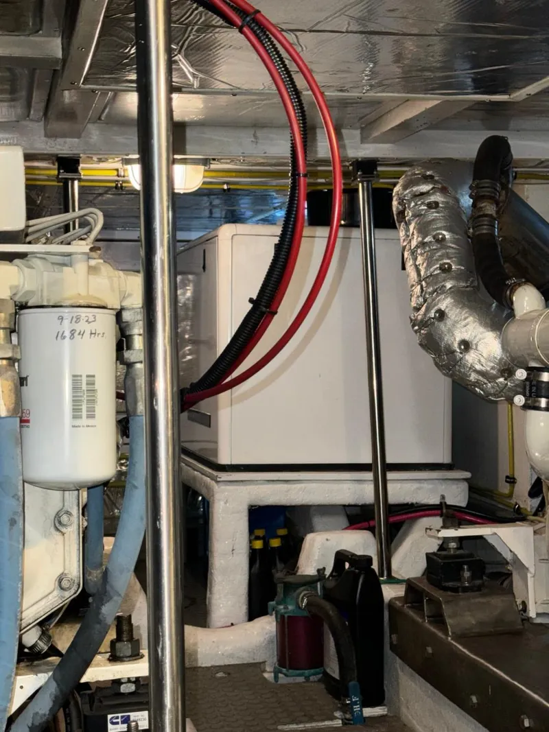 Slide: The Image of Engine room of a 2004 Ocean Alexander 42 yacht, showcasing mechanical components. - 33