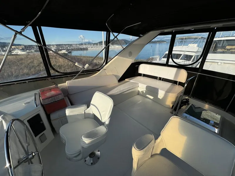 Slide: The Image of Interior view of 2004 Ocean Alexander 42 yacht with seating and steering wheel. - 34