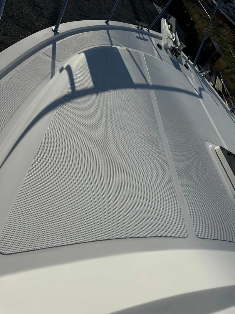 Slide: The Image of 2004 Ocean Alexander 42 yacht deck with textured surface and railing. - 36
