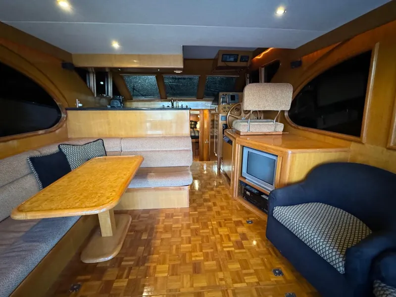 Slide: The Image of Luxurious interior of 2004 Ocean Alexander 42 yacht with wood finishes and cozy seating. - 4