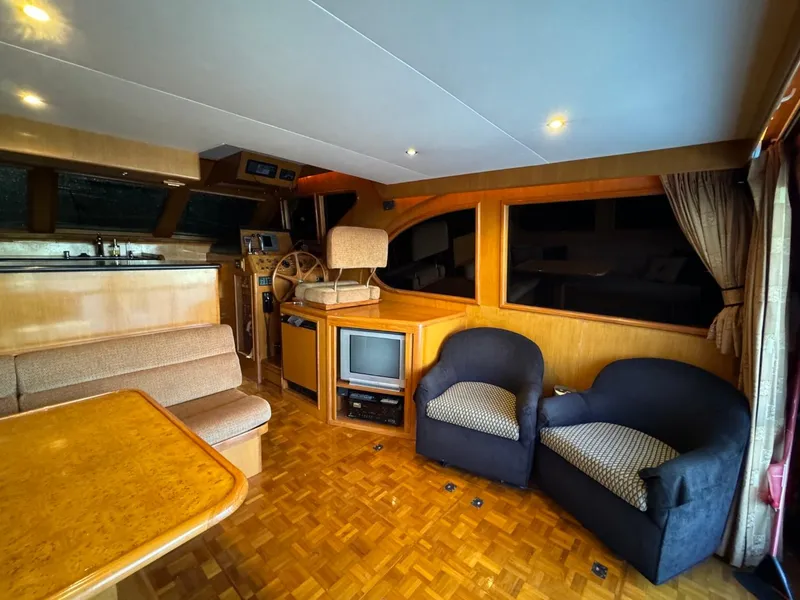 Slide: The Image of Interior of 2004 Ocean Alexander 42 yacht with seating, helm, and TV. - 6