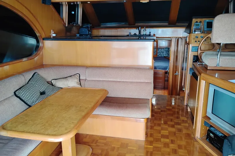 Slide: The Image of Interior of 2004 Ocean Alexander 42 Altus yacht with cozy seating and wooden finishes. - 8