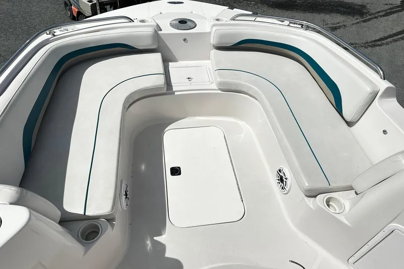 Slide: The Image of 2003 Godfrey Hurricane GS 211 boat interior with white seating and teal accents. - 10