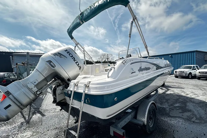 Slide: The Image of 2003 Godfrey Hurricane GS 211 boat with Honda outboard motor on trailer. - 2
