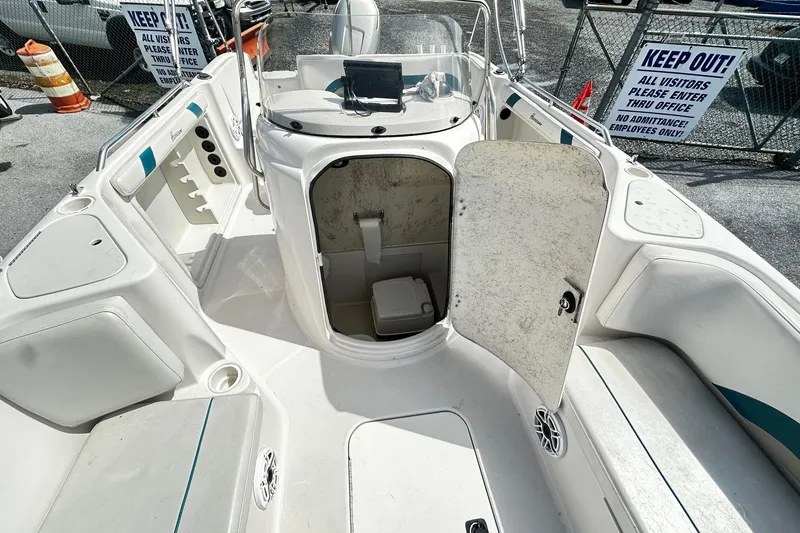 Slide: The Image of 2003 Godfrey Hurricane GS 211 boat interior with open storage compartment. - 4