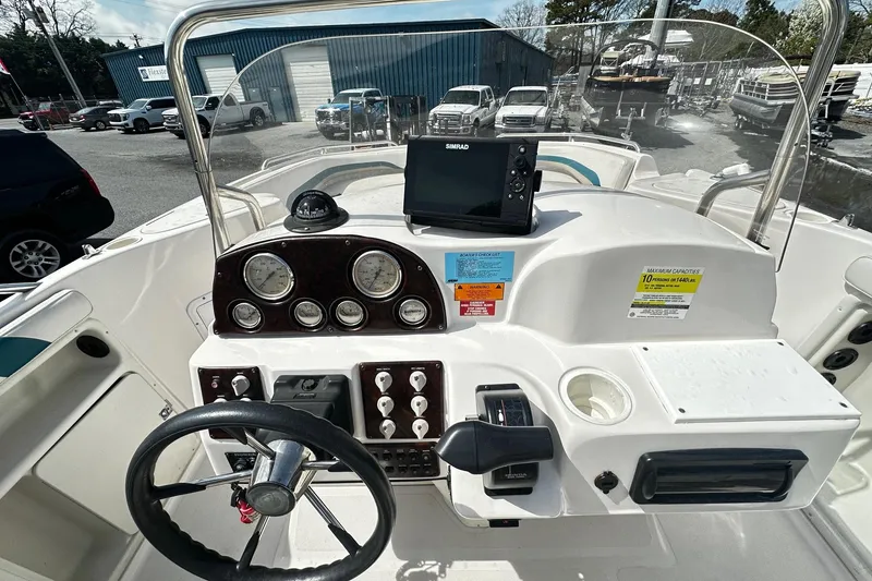 Slide: The Image of 2003 Godfrey Hurricane GS 211 boat dashboard with steering wheel and navigation equipment. - 7