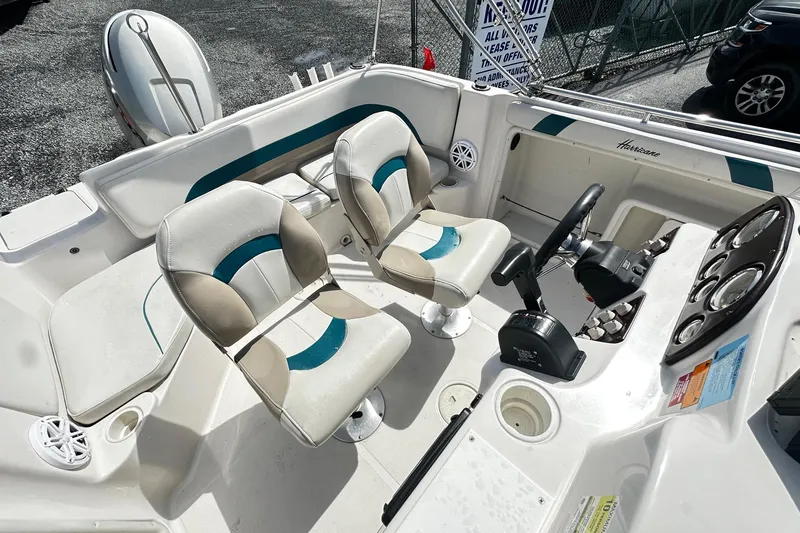 Slide: The Image of 2003 Godfrey Hurricane GS 211 boat interior with dual seats and steering console. - 8