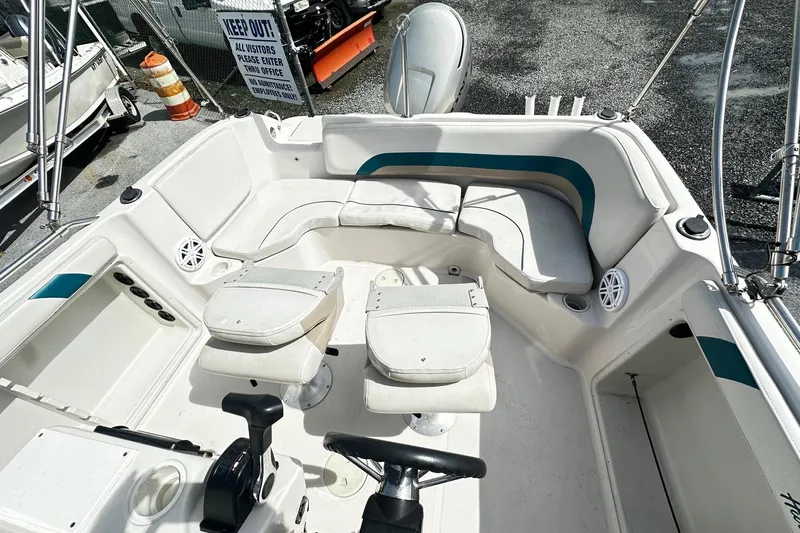 Slide: The Image of 2003 Godfrey Hurricane GS 211 boat interior with seating and steering wheel. - 9